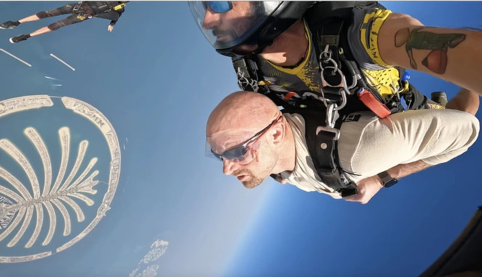 Chad E. Foster skydiving with Palm Island in the background
