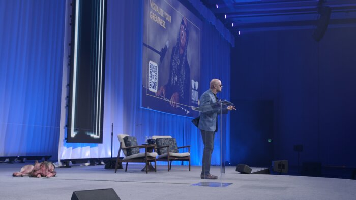 Chad E Foster delivering keynote at CCW Vegas with conference branding