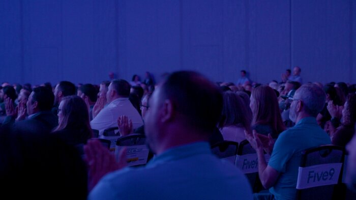 Wide conference hall shot showing Chad E Foster speaking to hundreds of attendees