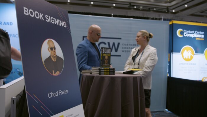 Chad E Foster signing Blind Ambition book for female conference attendee