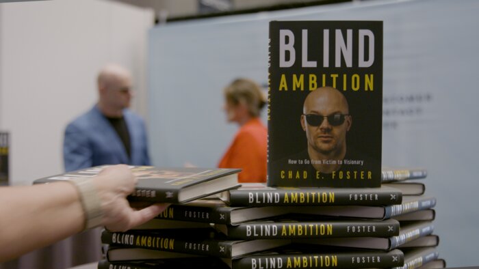 Stack of Blind Ambition books at Chad E Foster's book signing table