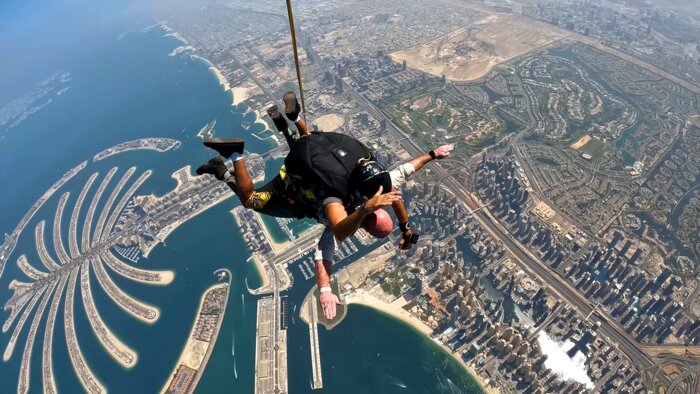 Chad E Foster skydiving over Dubai Palm Island, demonstrating courage and blind ambition