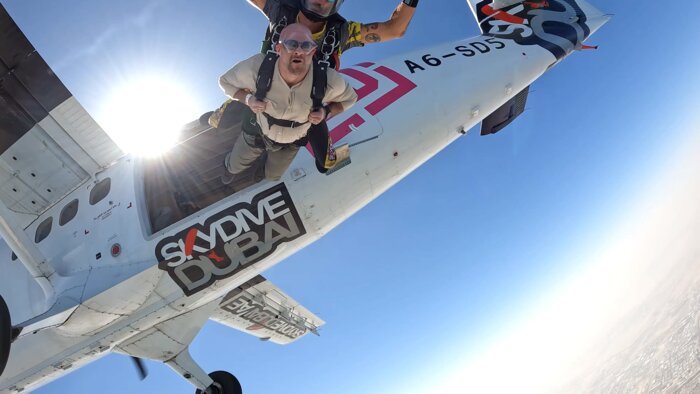 Chad E Foster preparing for skydive in Dubai plane, showing courage and preparation
