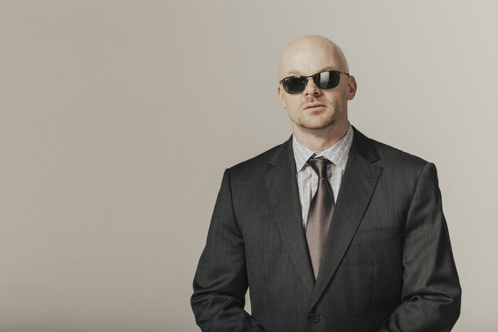 Chad E Foster in business suit, professional keynote speaker headshot