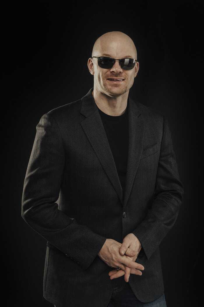 Vertical portrait of Chad E Foster in business suit for speaker bureau