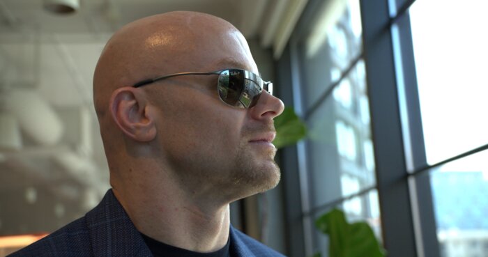 Close portrait of Chad E Foster by window with natural lighting, artistic composition