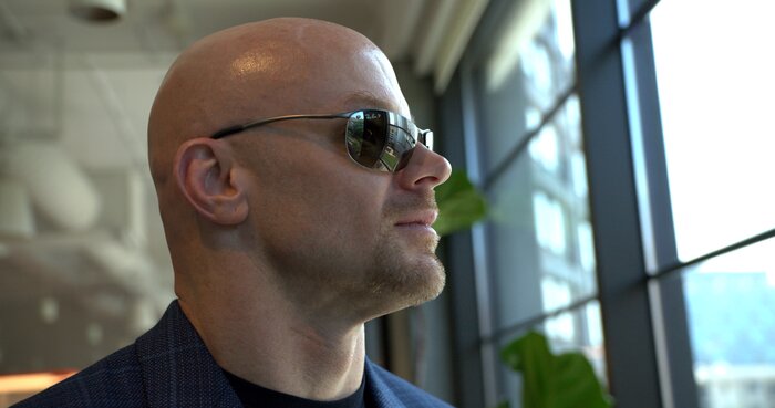 Close-up portrait of Chad E Foster by window with natural lighting