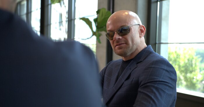 Corporate boardroom meeting with Chad E Foster providing leadership guidance