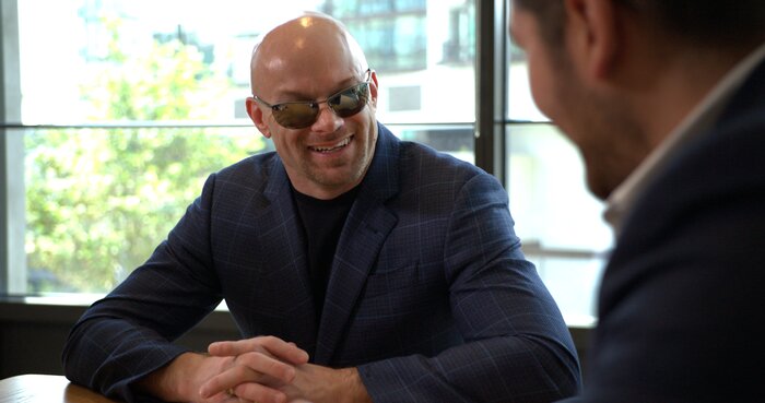 Chad E Foster sharing a laugh during business meeting, showing approachable leadership