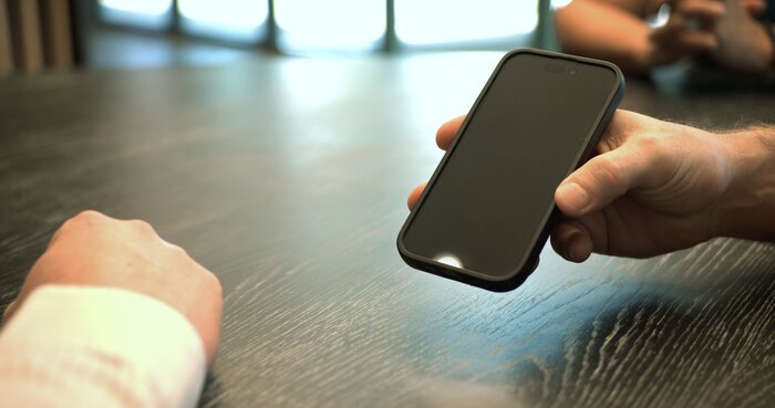 Chad E Foster conducting business phone call in corporate environment