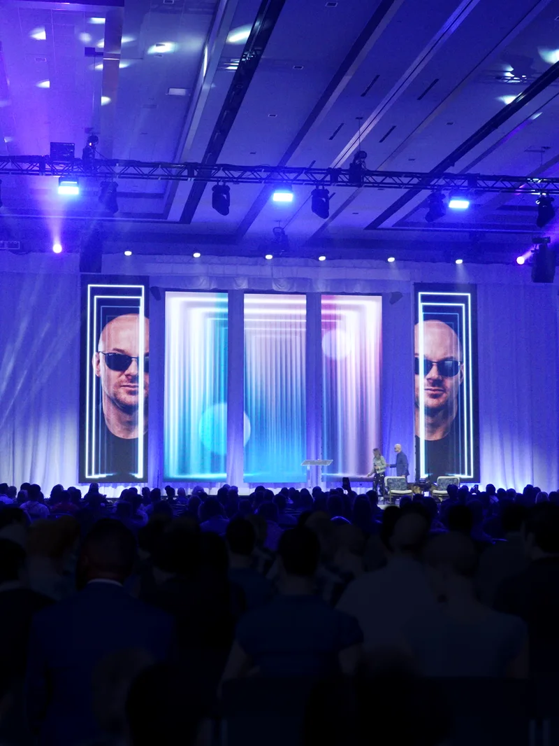 Chad E. Foster speaking on stage in Dallas