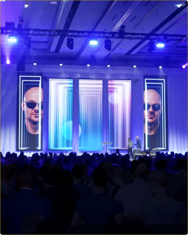 Chad E. Foster speaking on stage in Dallas